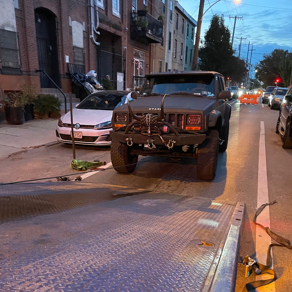 Garraud Towing truck transporting a vehicle in Philadelphia
